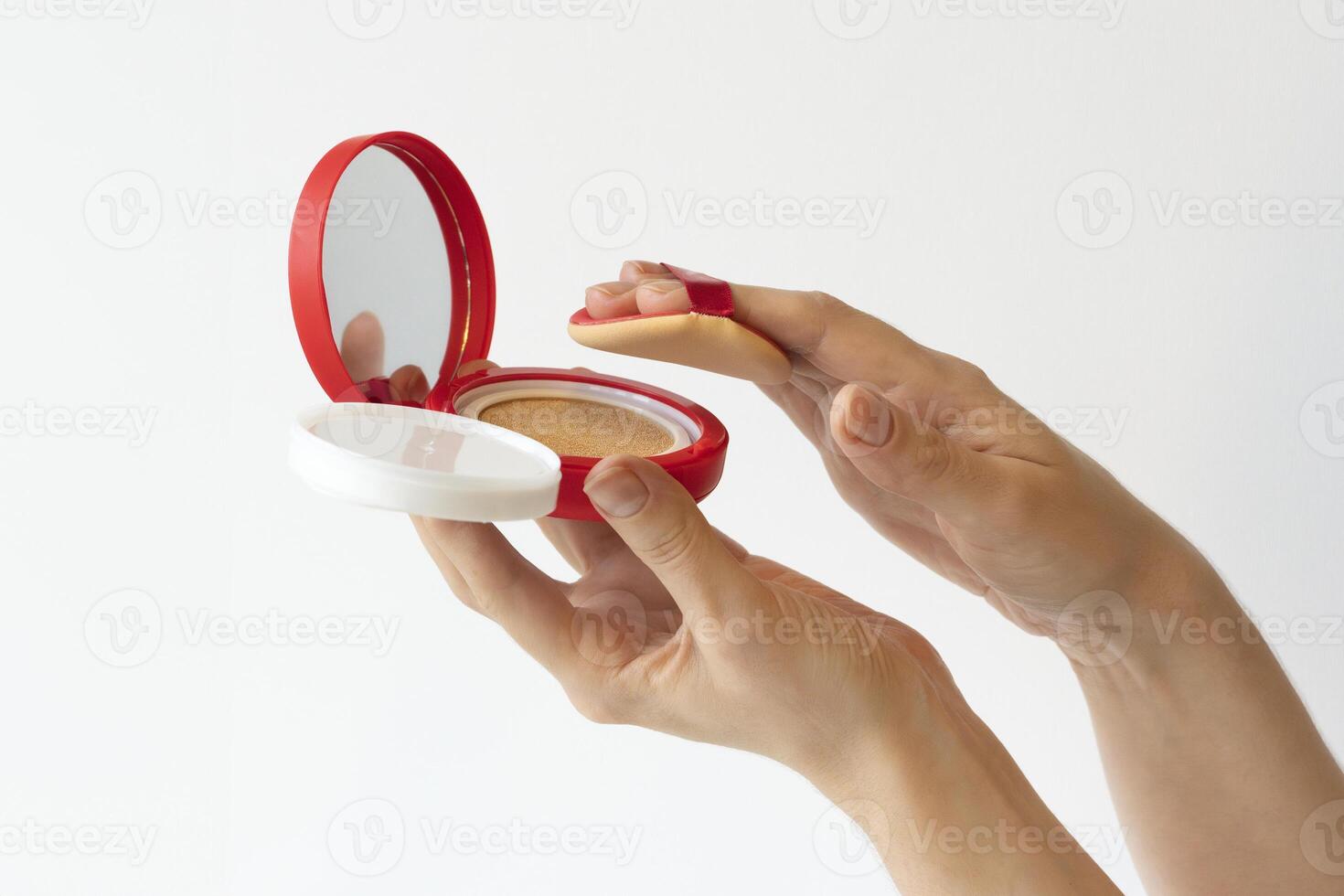 Woman hands with cushion foundation in red package, makeup beauty product liquid foundation, korean skincare tonal foundation photo