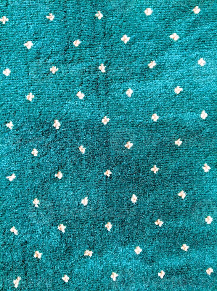 A green and white polka dot fabric with small dots photo