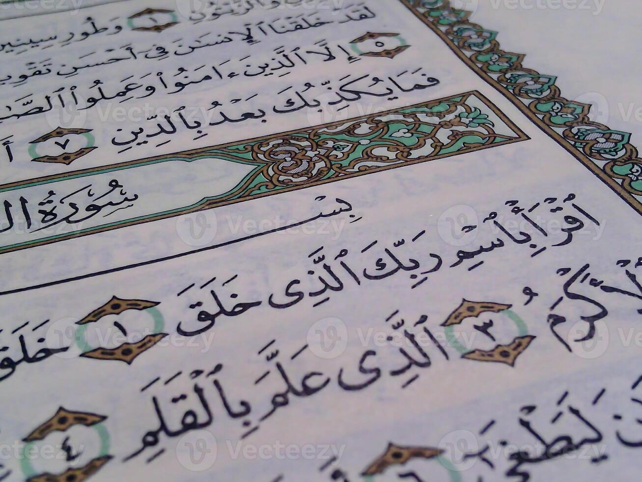 Closeup of open quran with surah of al Alaq or read it photo