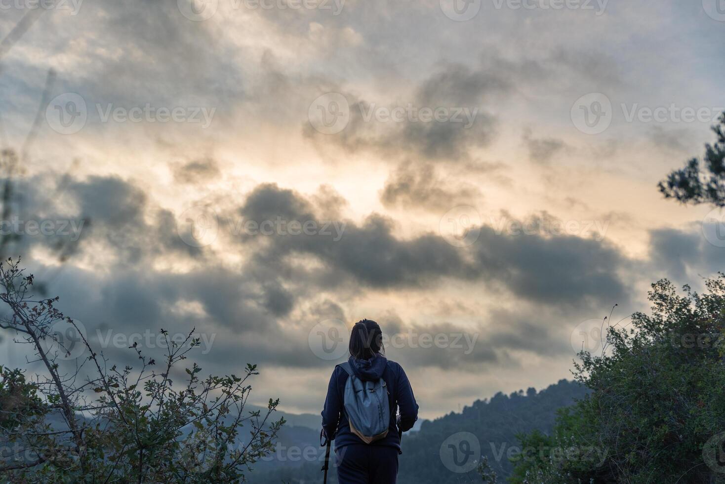 Hiker contemplates the immensity of nature during his mountain excursion. photo
