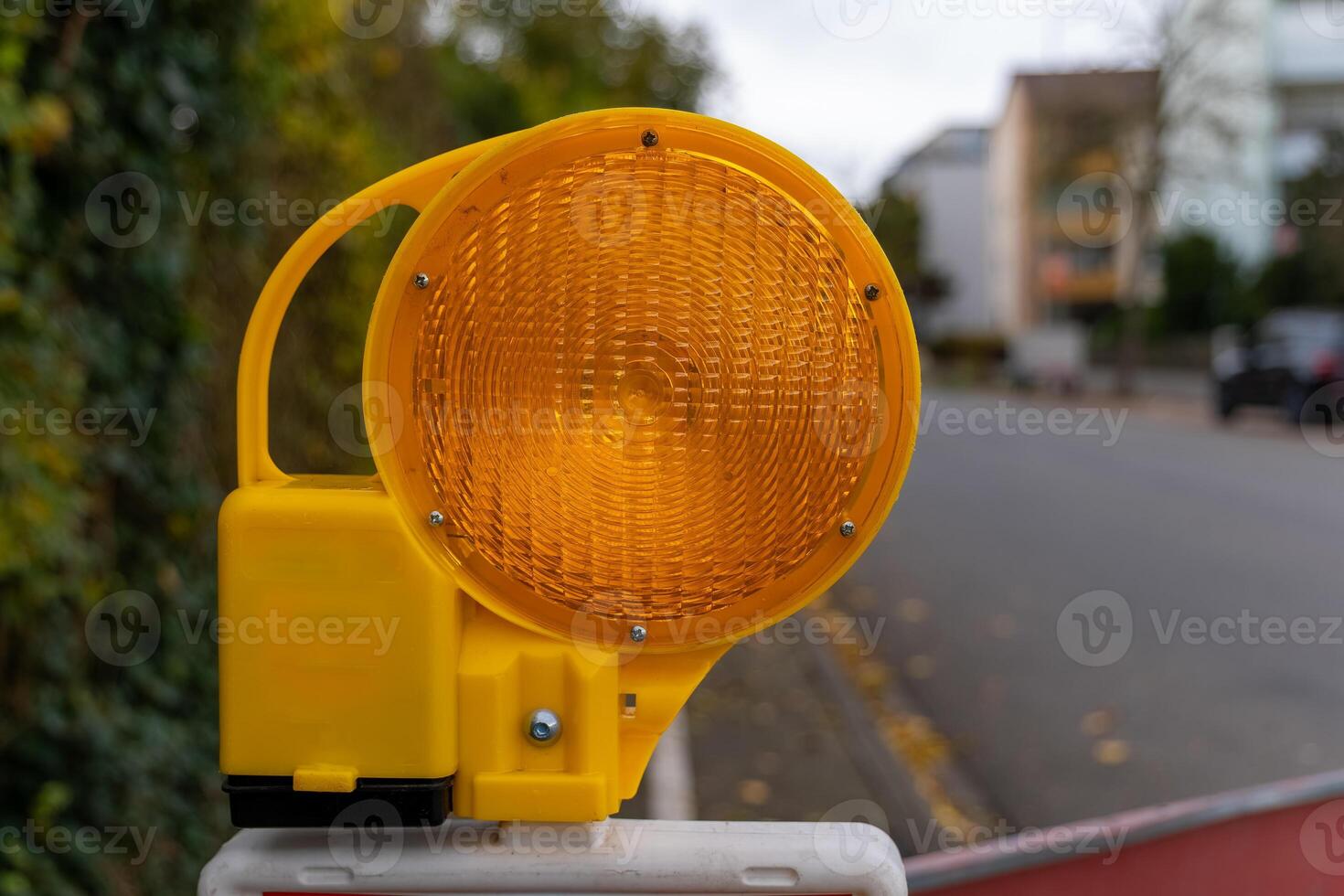 A close-up view of a portable, yellow safety light photo