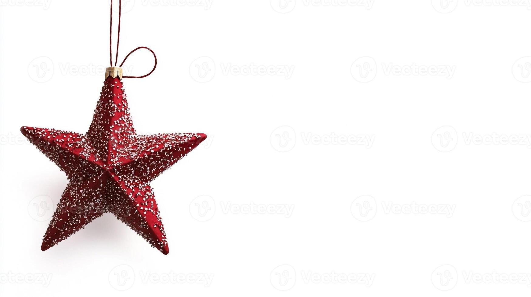 A red star ornament hanging from a string photo