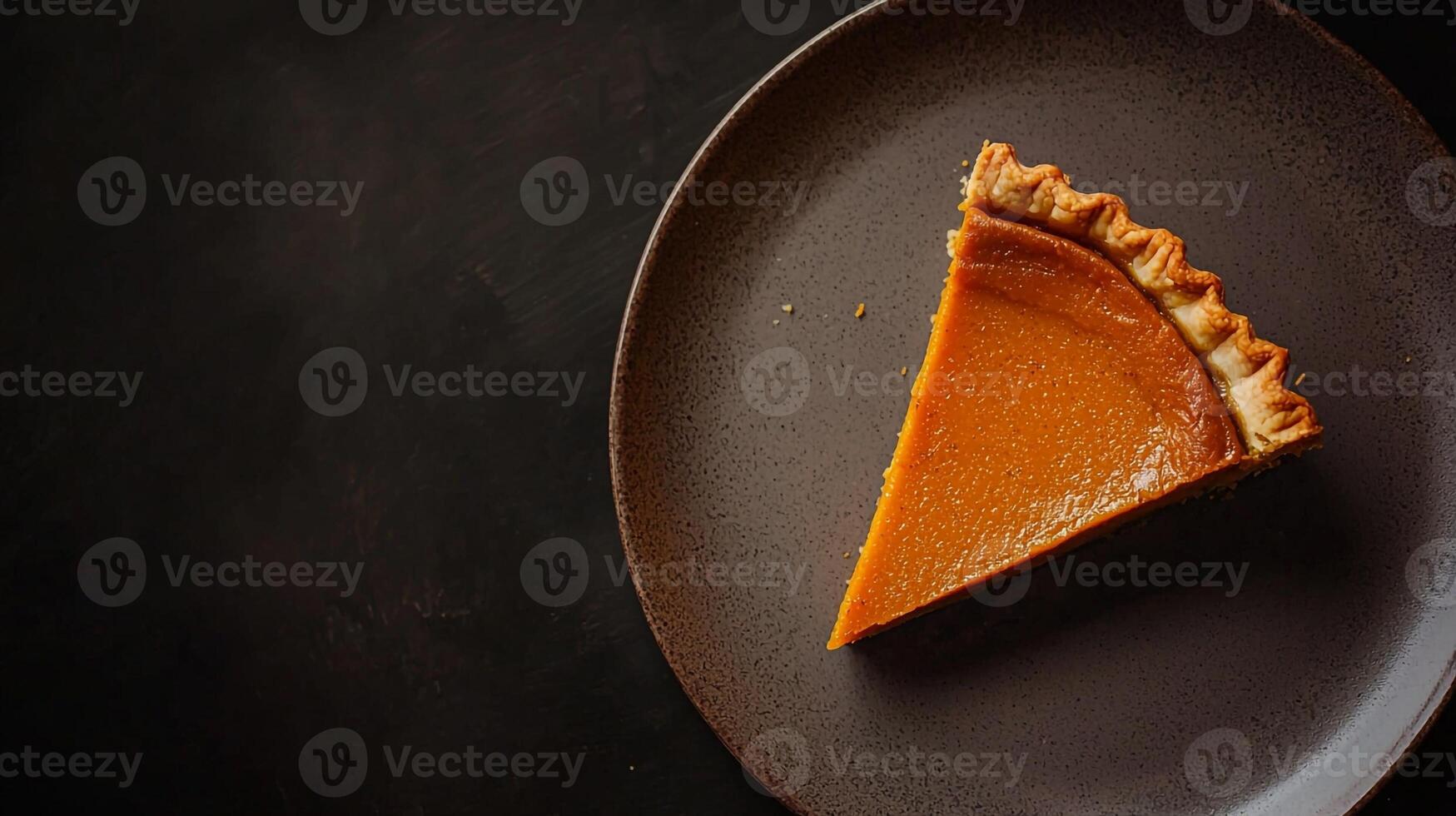 A slice of pumpkin pie on a plate photo