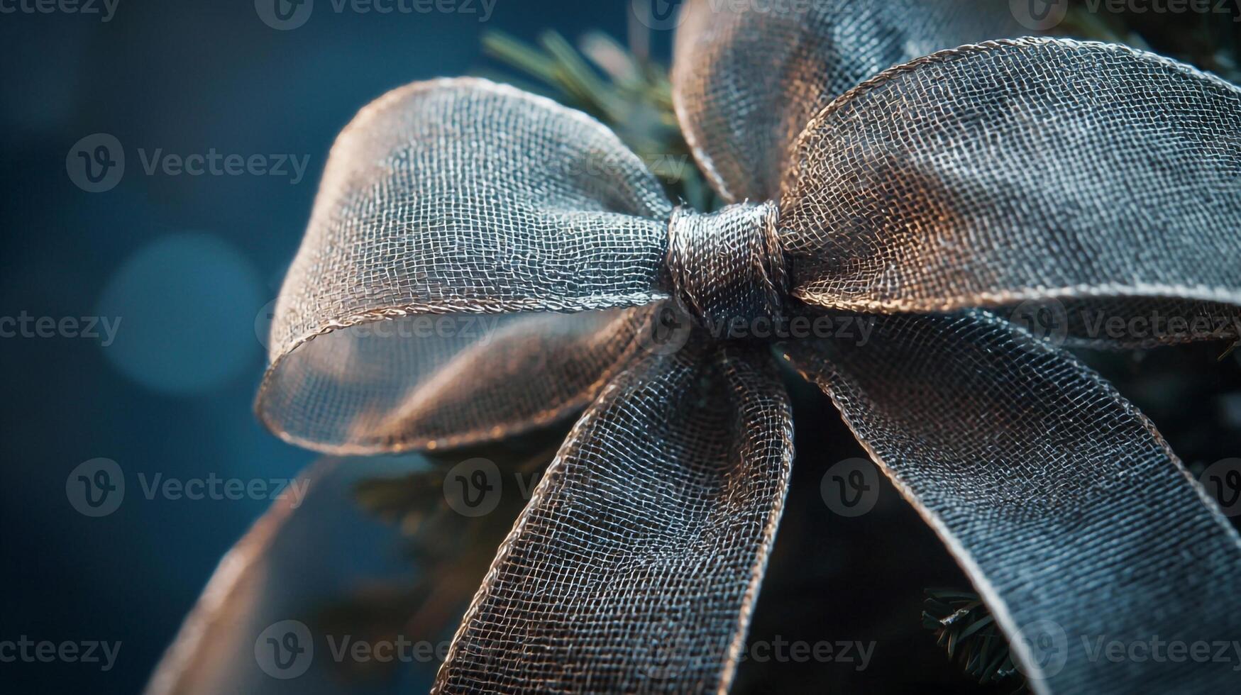 A silver ribbon is tied around a christmas tree photo