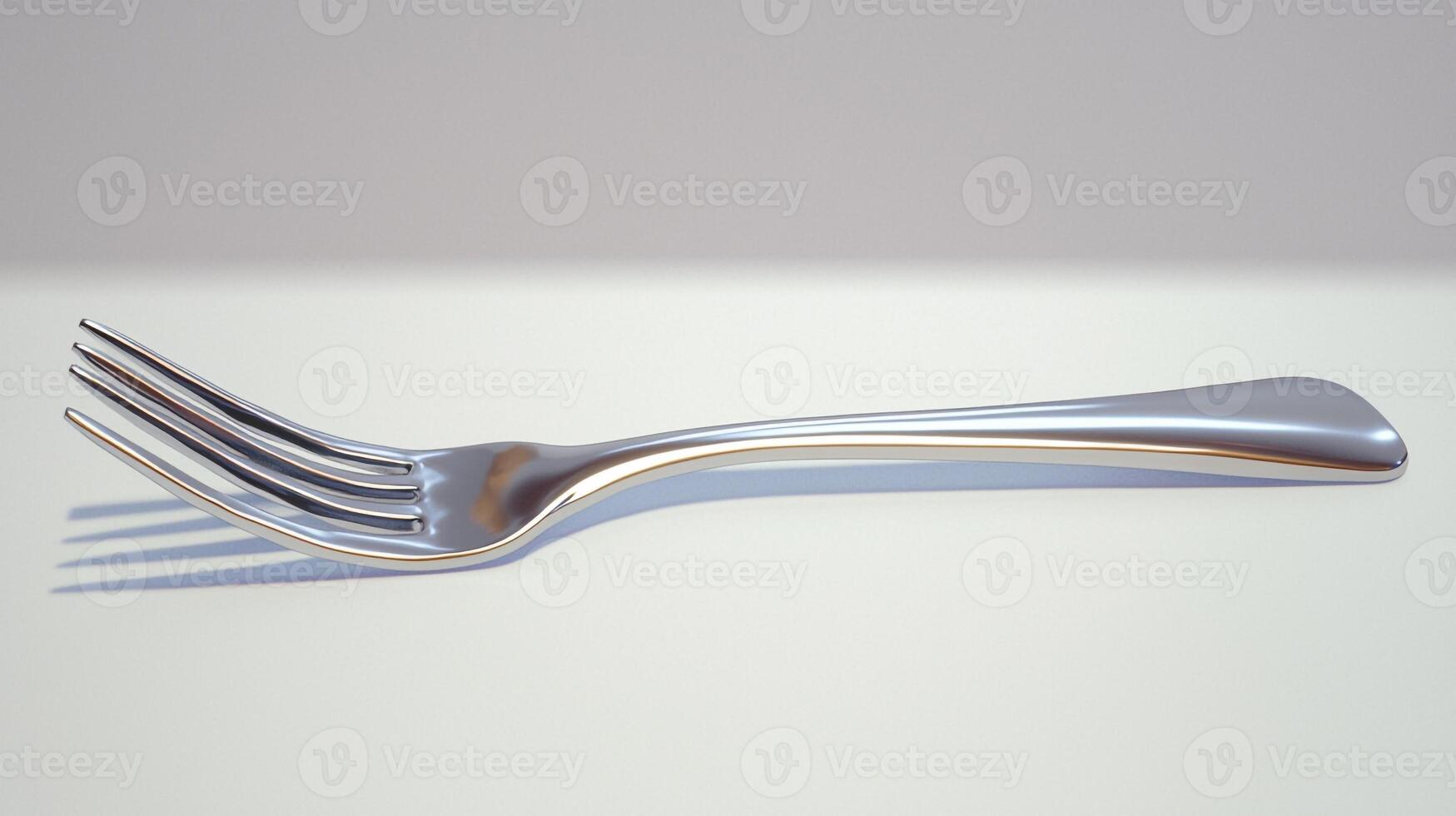 A fork with a silver handle on a white surface photo