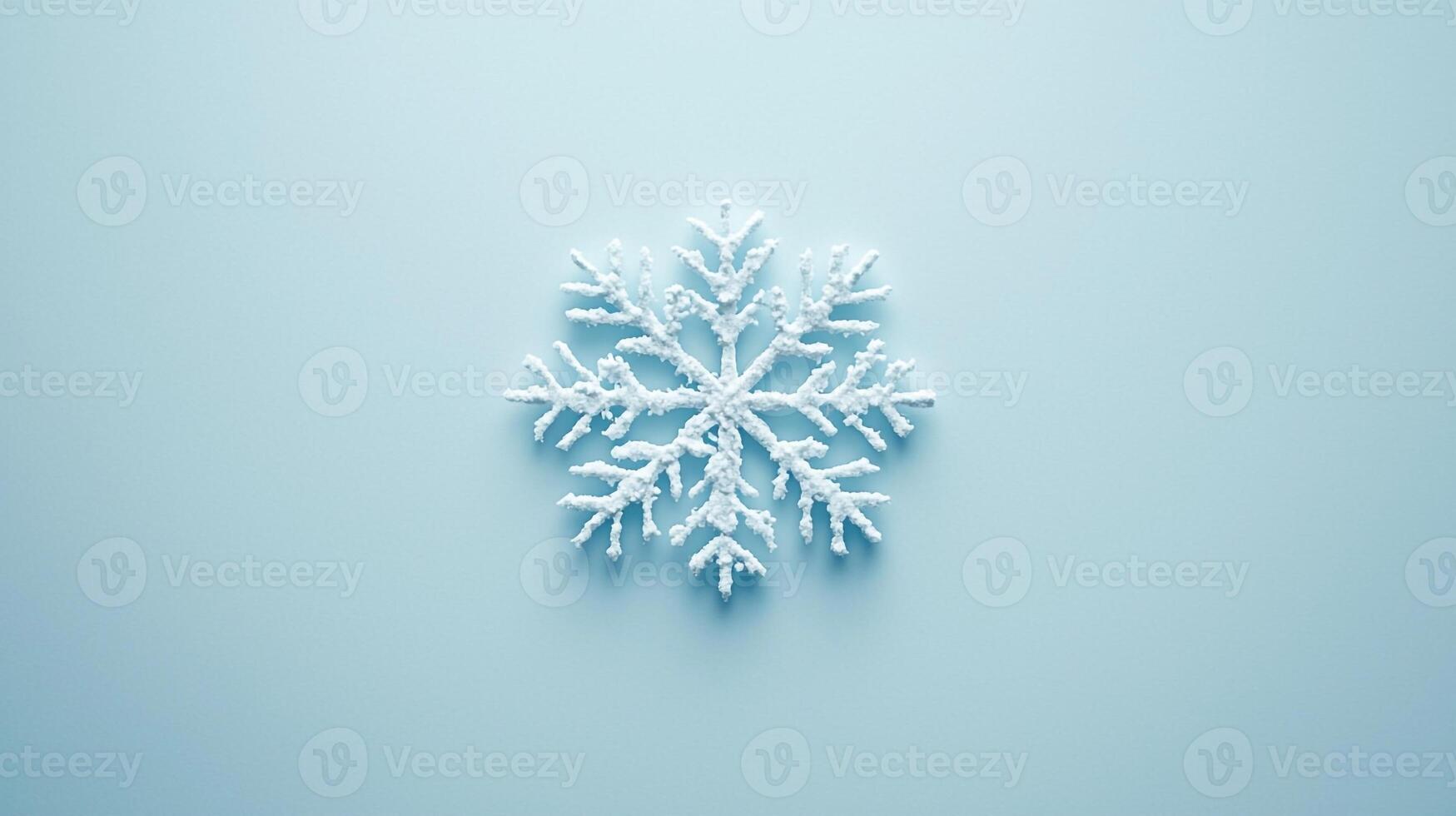 A snowflake is shown on a blue background photo