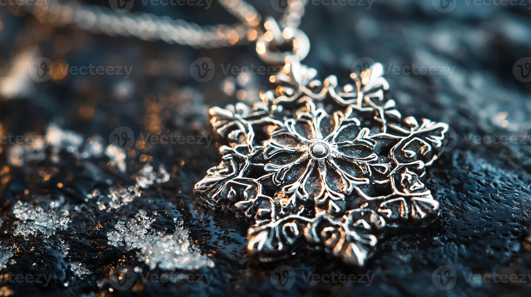 A silver snowflake pendant on a chain photo