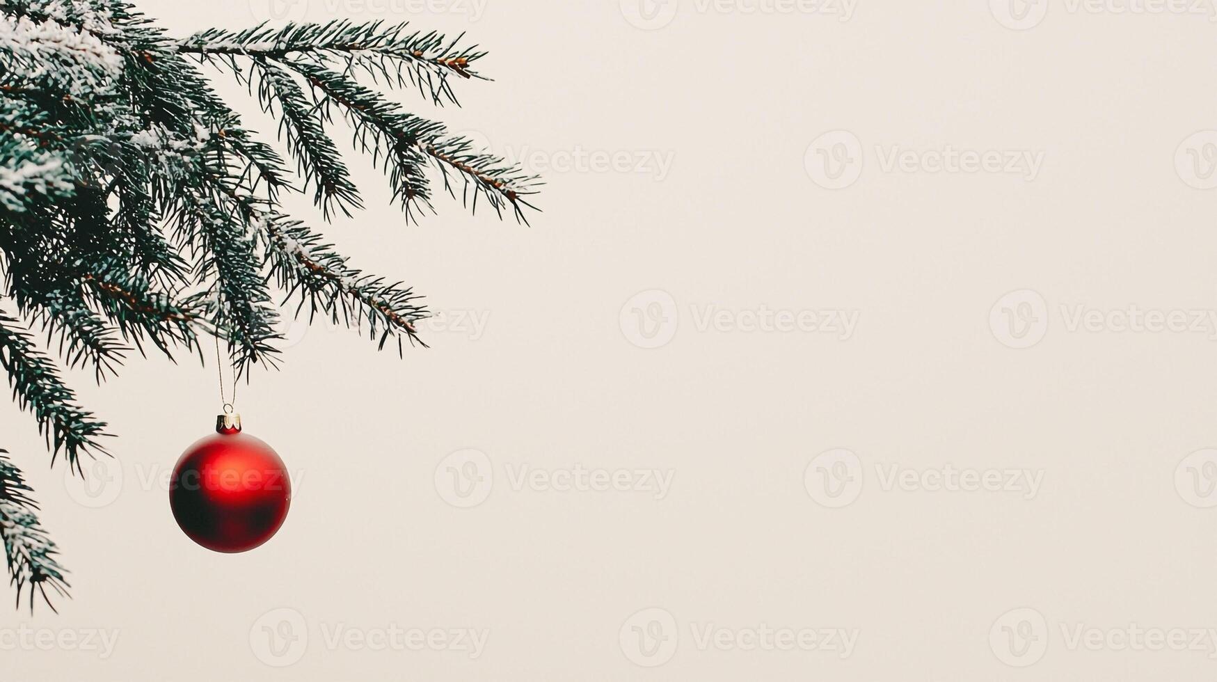 Christmas tree with red ball hanging from branch photo