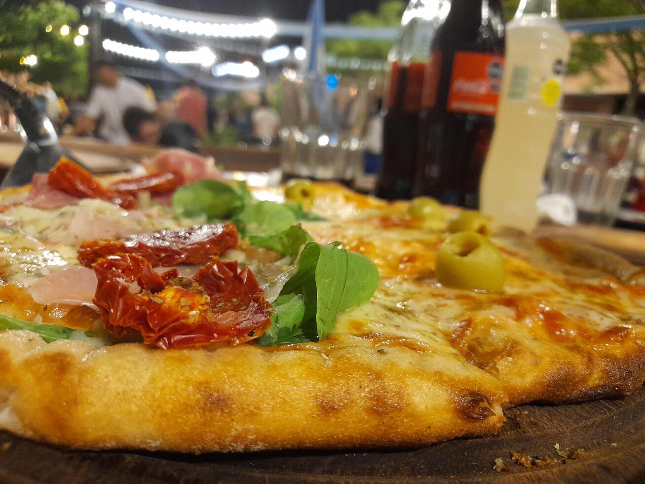 A pizza on a wooden table photo