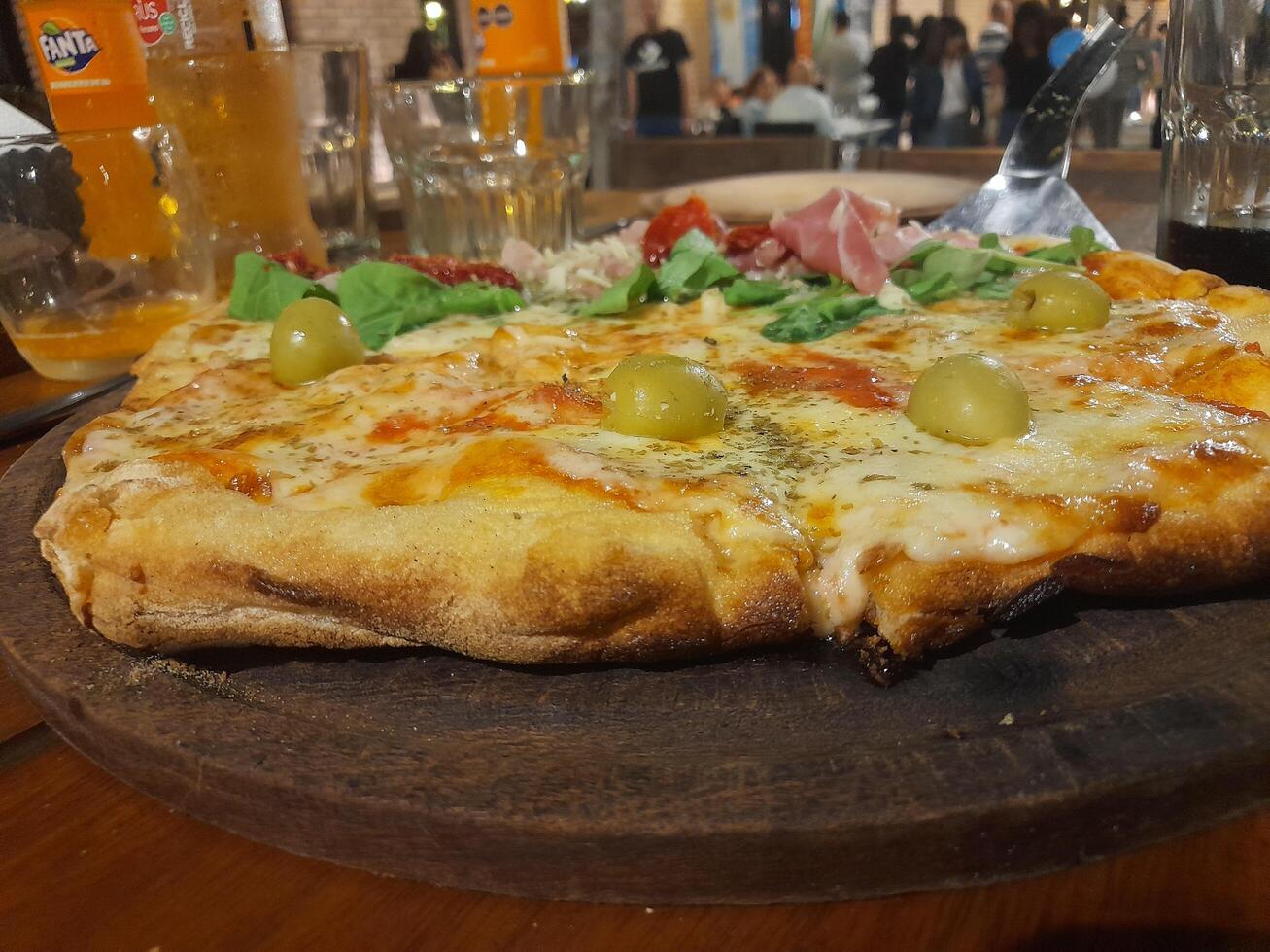 A pizza on a wooden table photo