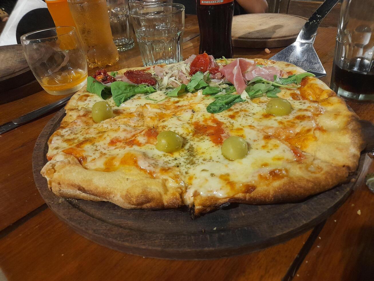A pizza on a wooden table photo