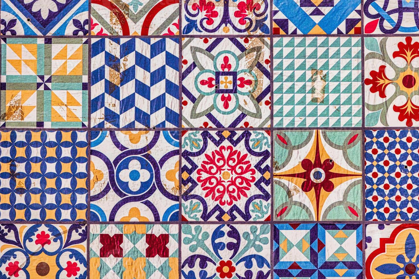 A collection ceramic of decorative ceramic tiles displays an array of intricate patterns and vibrant colors, including blues, reds, and greens photo