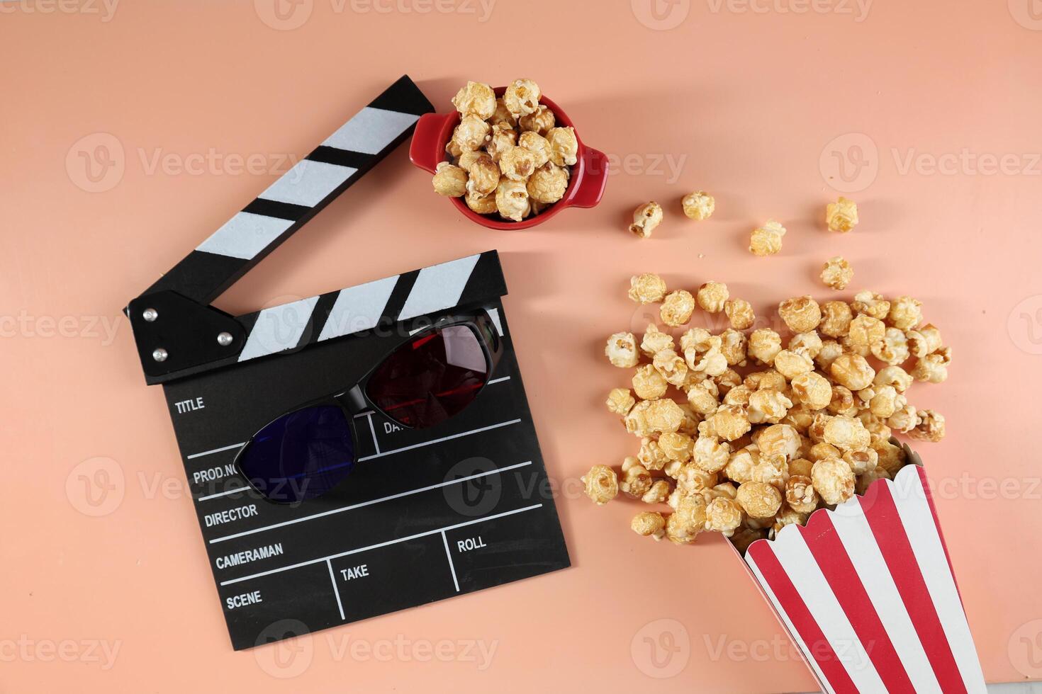 Tasty Popcorn in Paper Buckets, Movie Clapper and 3D Eyeglasses on a Bright Colored Background. photo
