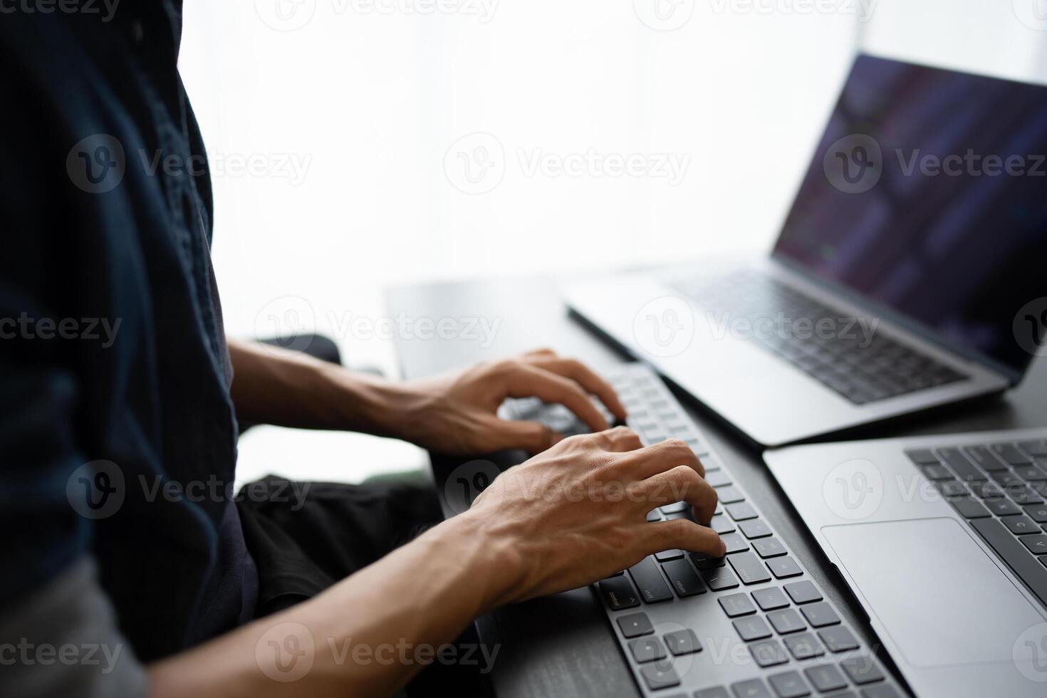Asian man software engineer Working on Computer at office desk for writing program code IT Software Engineer finding errors tech support devops creating digital photo