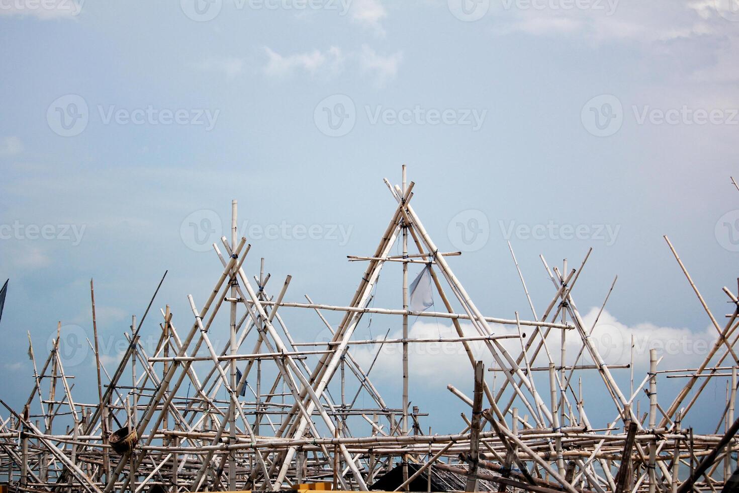 Intricate Bamboo Scaffolding Structure Above the Sea photo