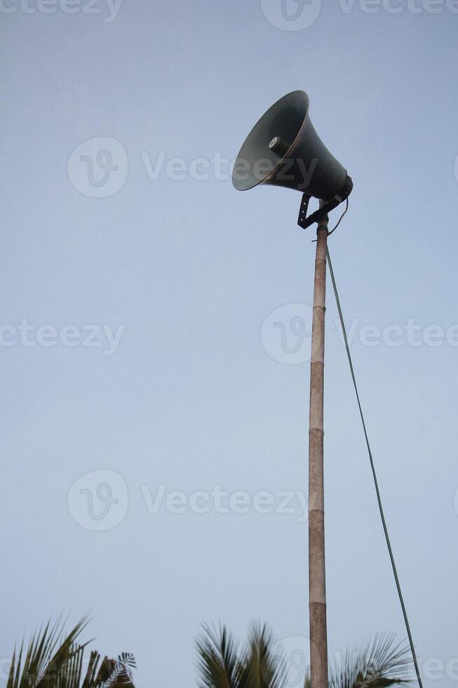 Tall Loudspeaker Pole Against Clear Sky, Symbolizing Communication and Public Announcements photo