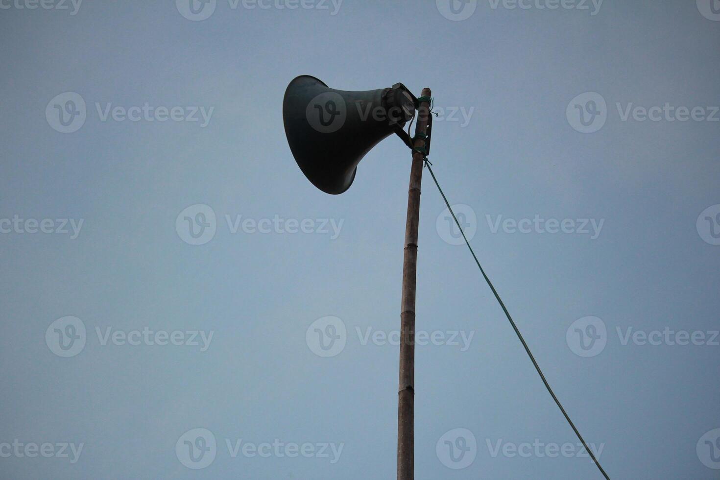 Tall Loudspeaker Pole Against Clear Sky, Symbolizing Communication and Public Announcements photo