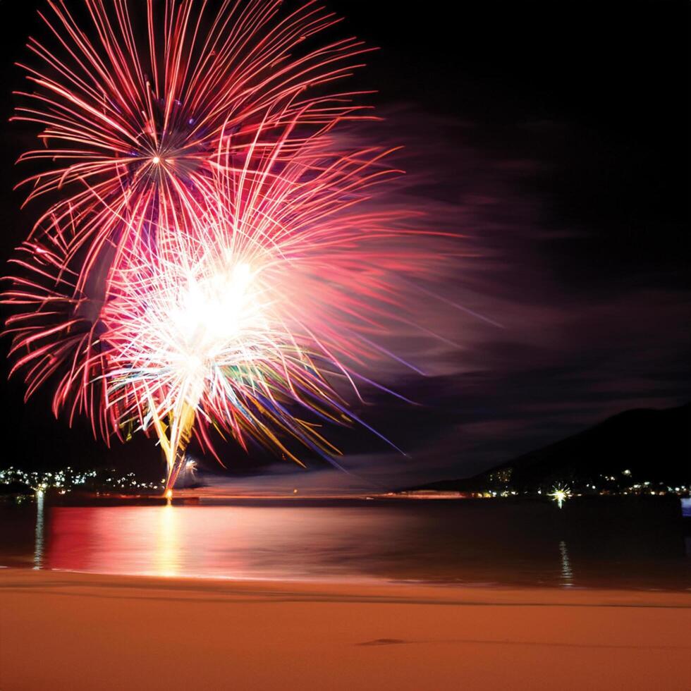 beautiful view of fireworks on the beach at night photo