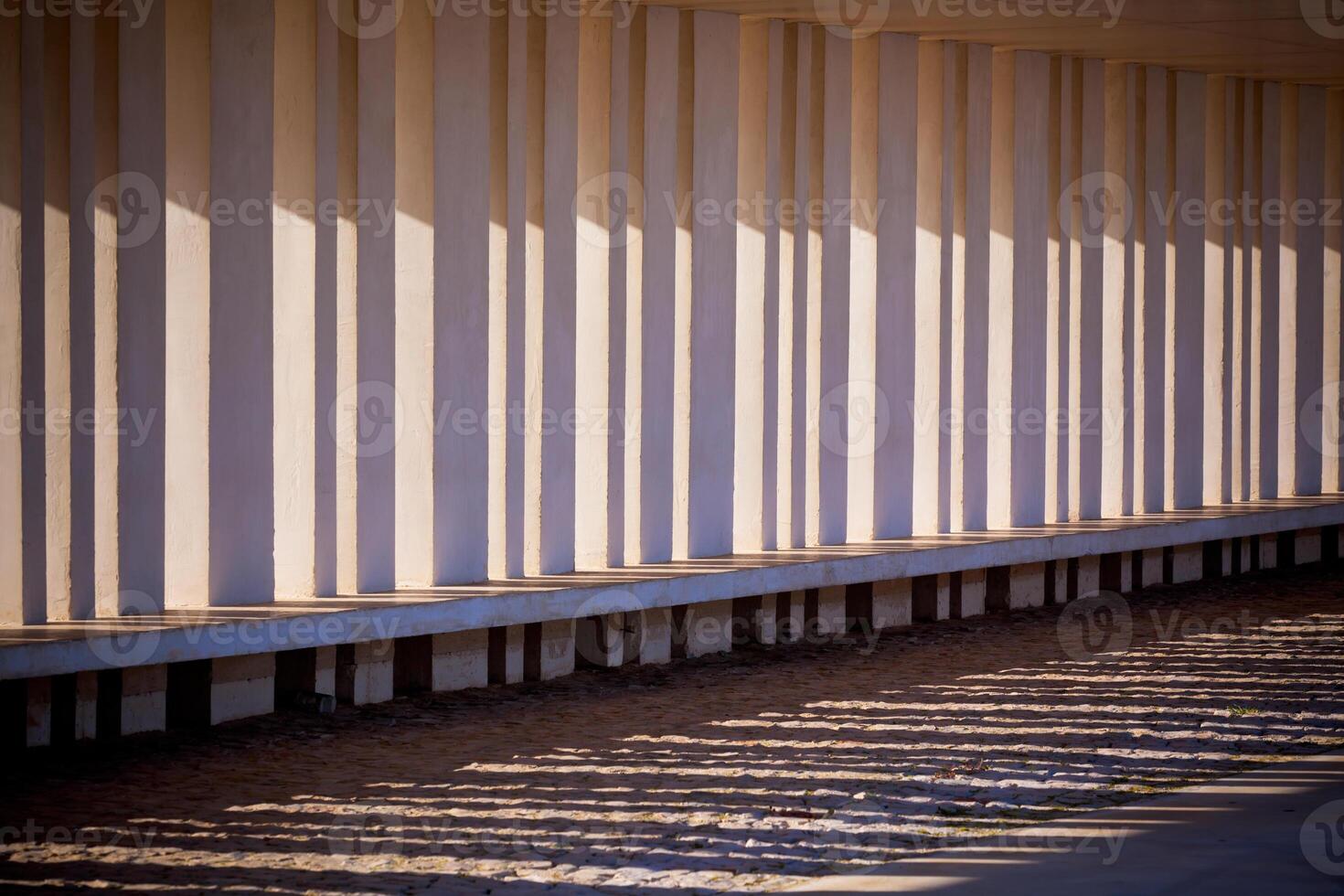 Sunlight and Shadows Through Columns of Building photo