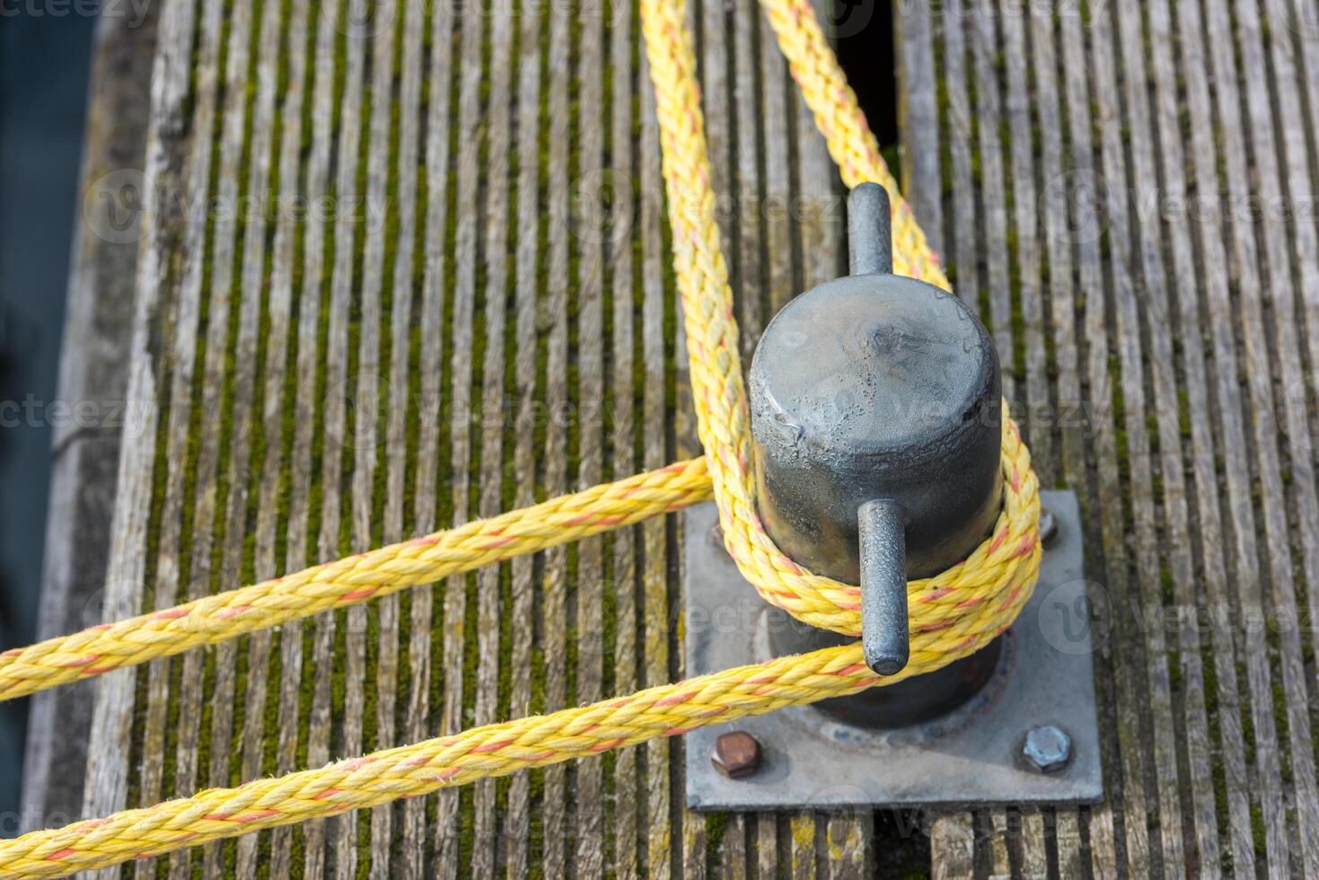 Mooring rope tied around a cleat photo