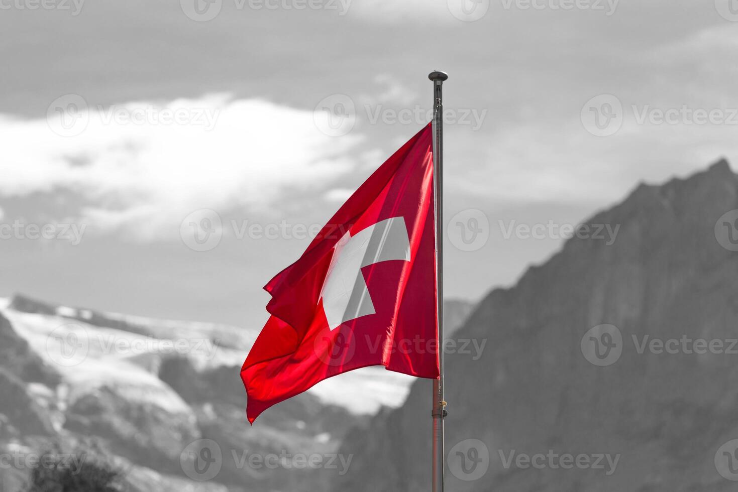 Swiss flag against Alps mountains photo
