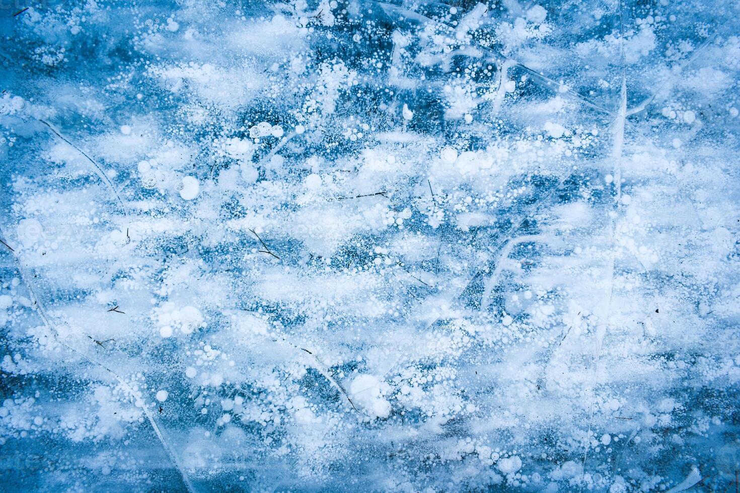 Background. Blue ice with bubbles and cracks. photo