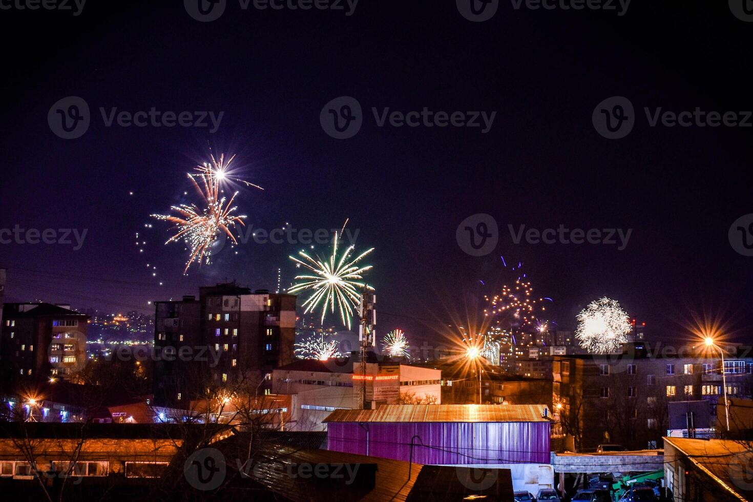 multi-colored fireworks on a black sky background. above city photo