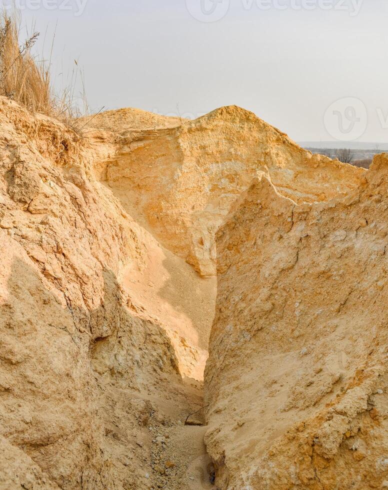 Large mountains of yellow sand. Sand quarry. Quarry sand mining. photo