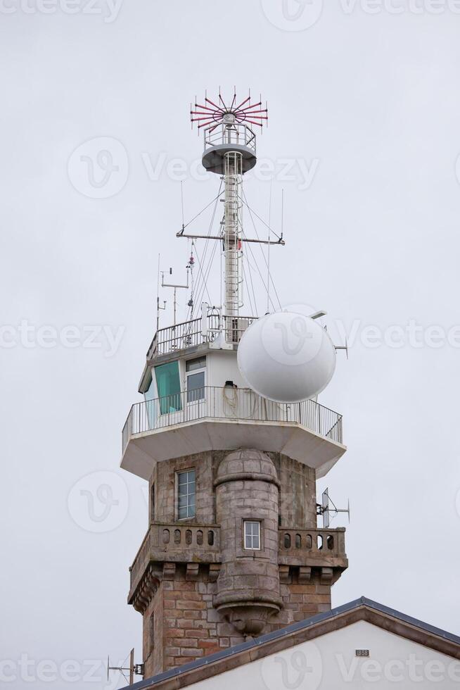 Old stone lighthouse with modern equipment photo