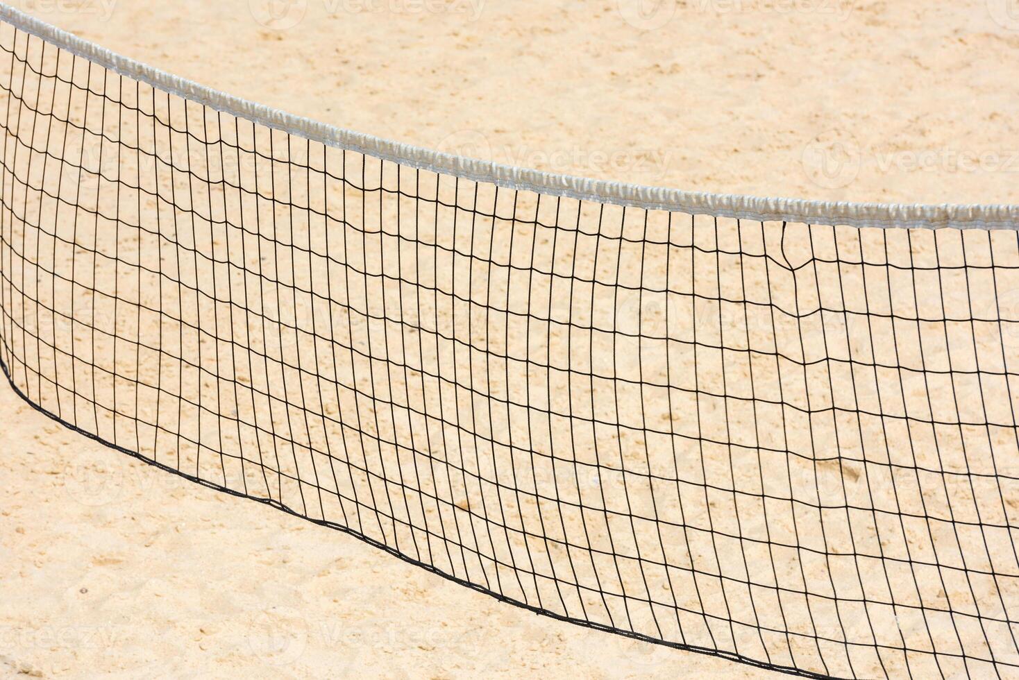 volleyball net on empty sand beach photo