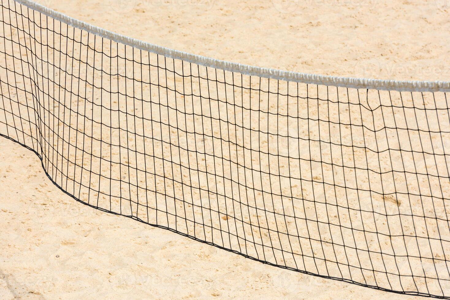 volleyball net on empty sand beach photo