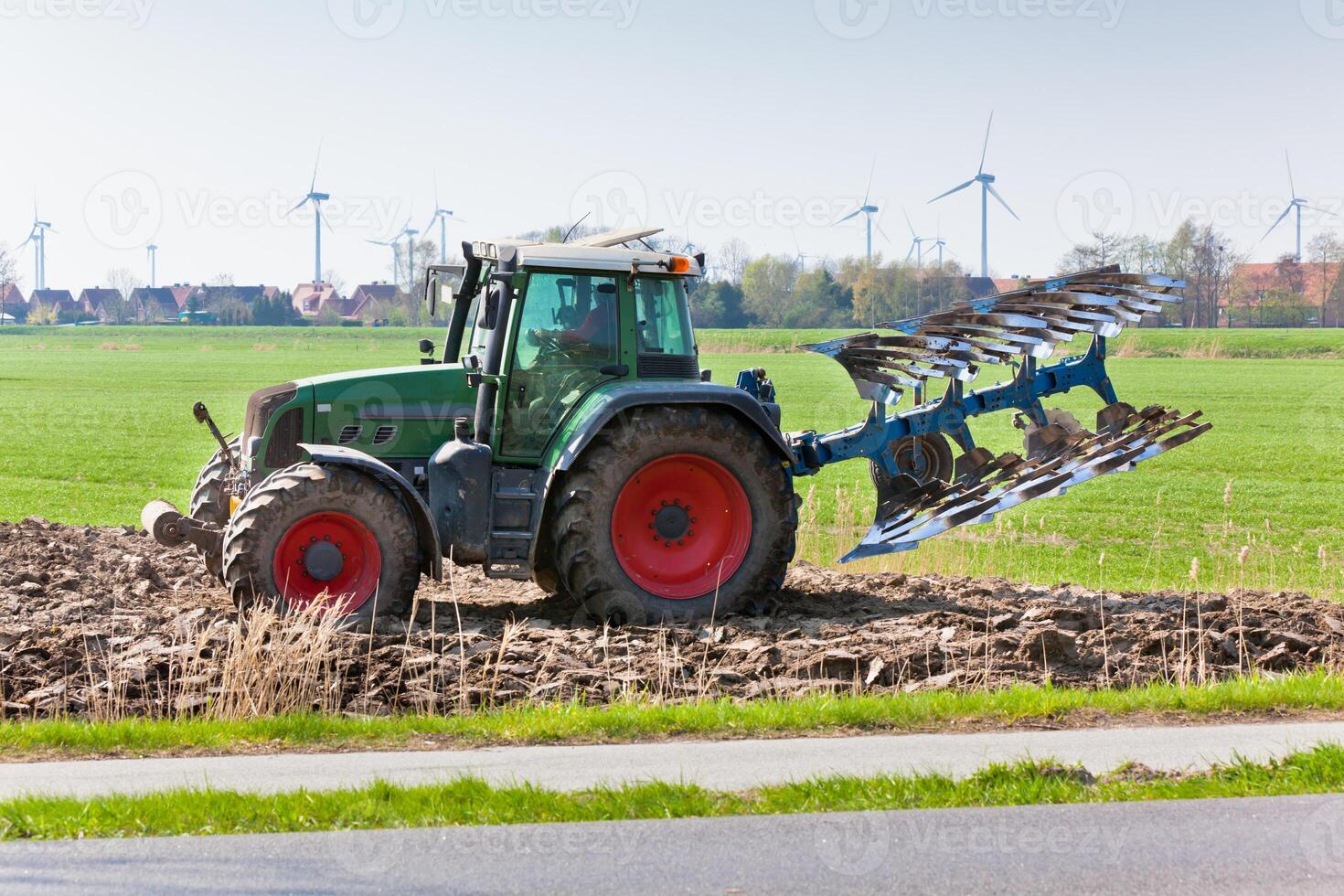 Tractor with plowes on the spring field. photo