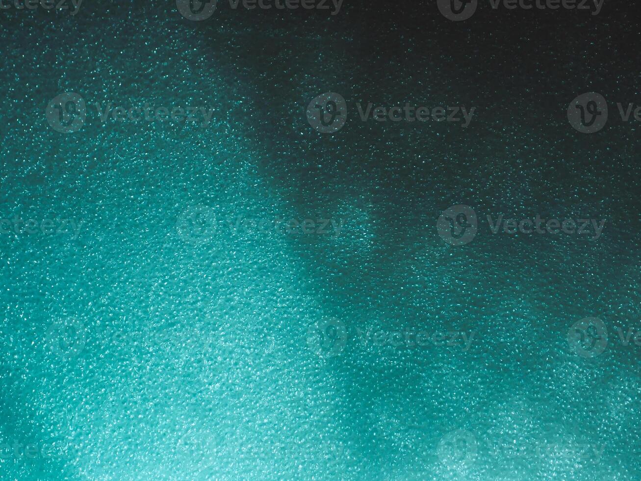 Light reflects blue shadows on a foam board in the dark for a minimalist abstract background. photo