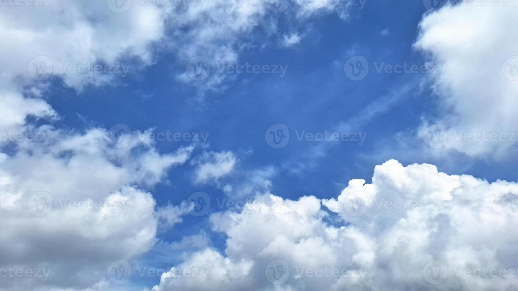 The beauty of a bright blue sky with white clouds that have a soothing effect. This beautiful color combination with blue sky background. photo