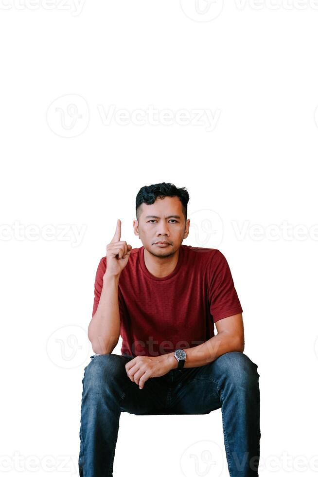Southeast Asian man pointing upward with a focused expression photo