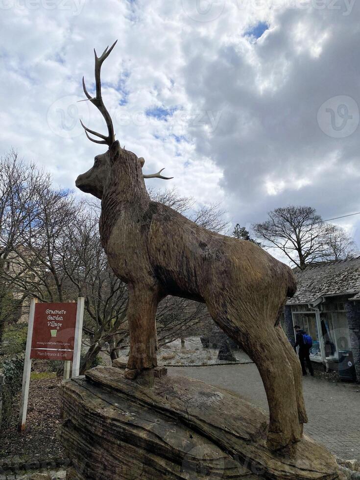 A statue of a deer on a rock photo