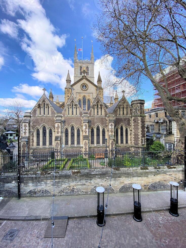 A large church with a tower and a fence photo