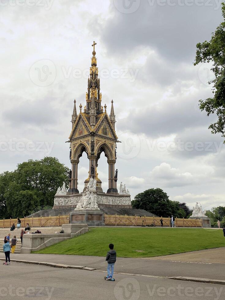 A large statue with a tower in the middle of a park photo
