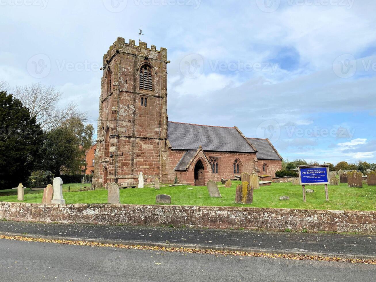 A church with a steeple and a sign on it photo