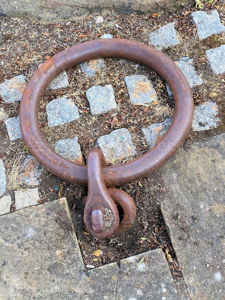 A rusty ring on the ground photo