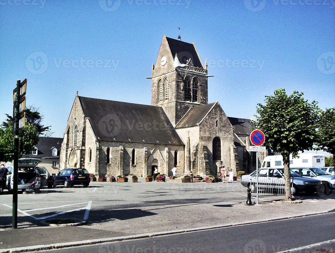 A church with a clock tower on the side of the road photo
