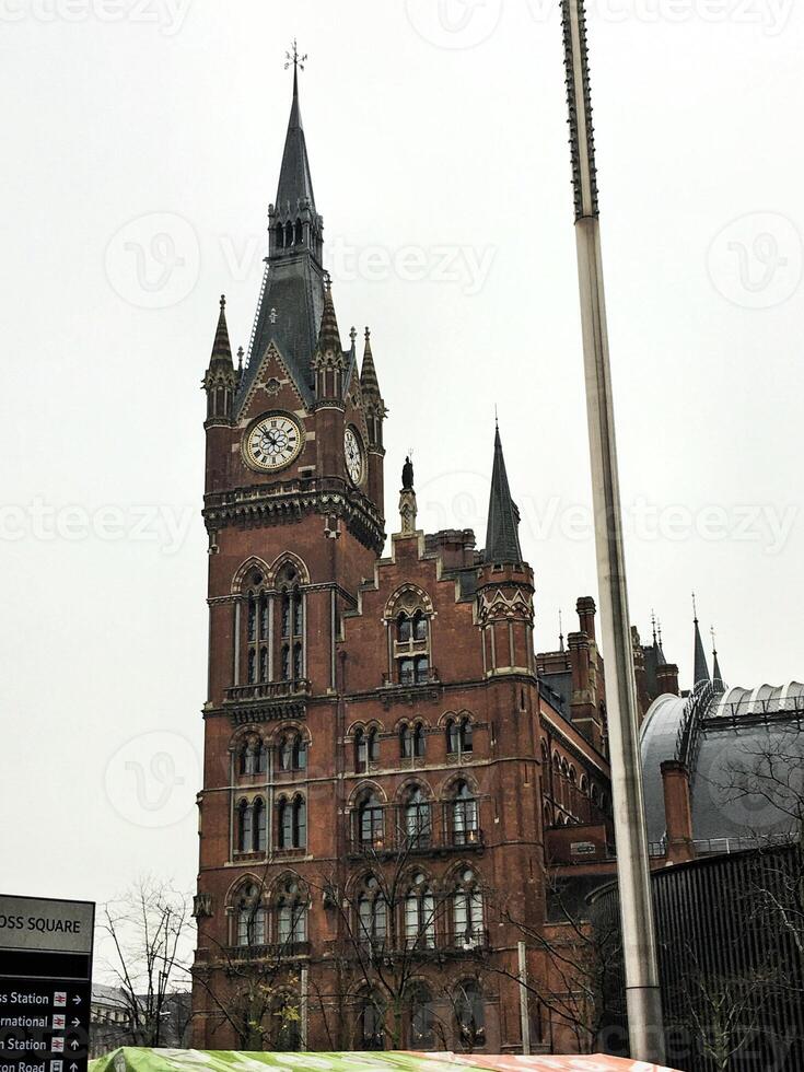 A large building with a clock tower and a bus photo