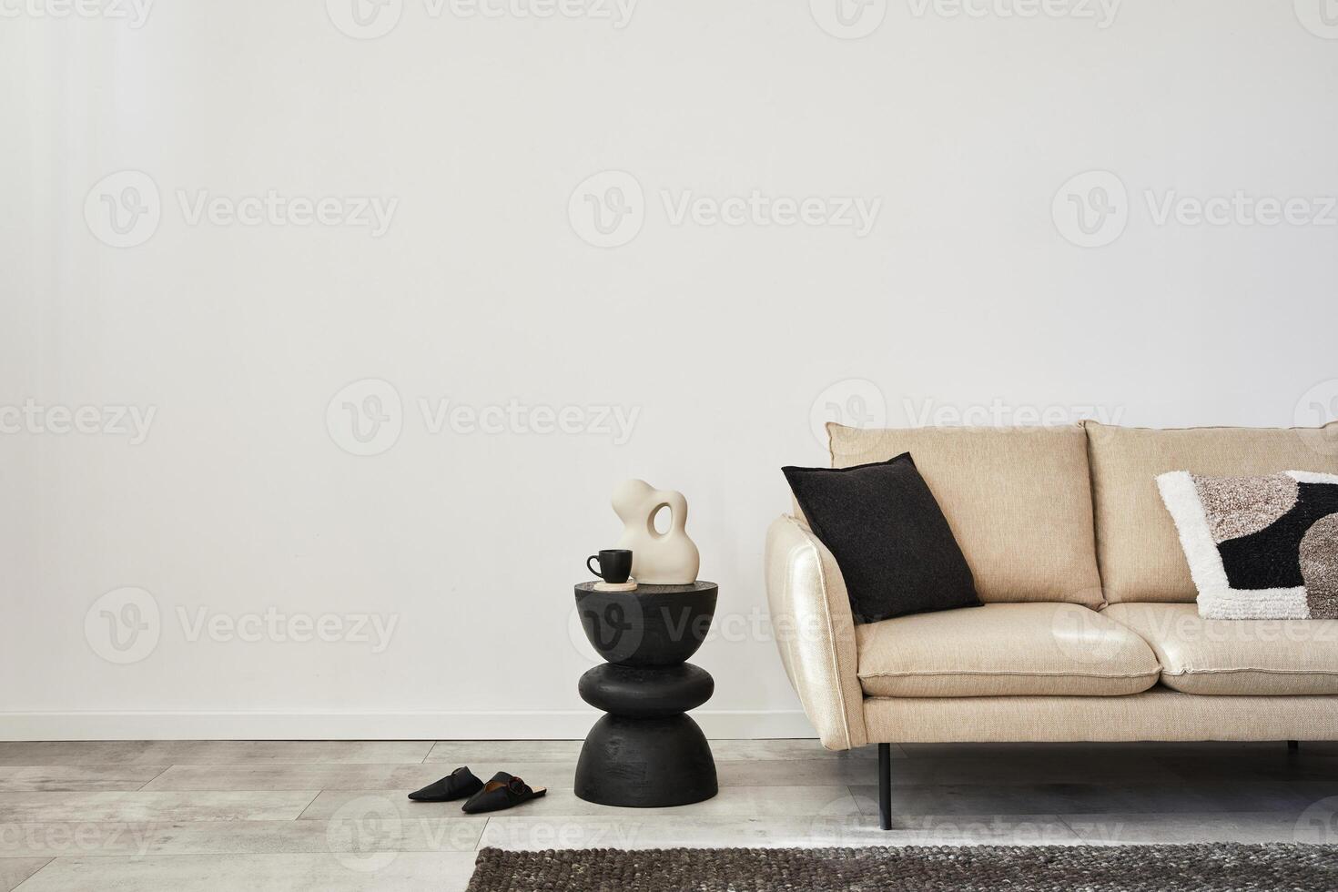 Creative composition of elegant minimalisit living room interior. Beige modern sofa, side table and stylish personal accessories. Wallpaper. Copy space. Template. photo