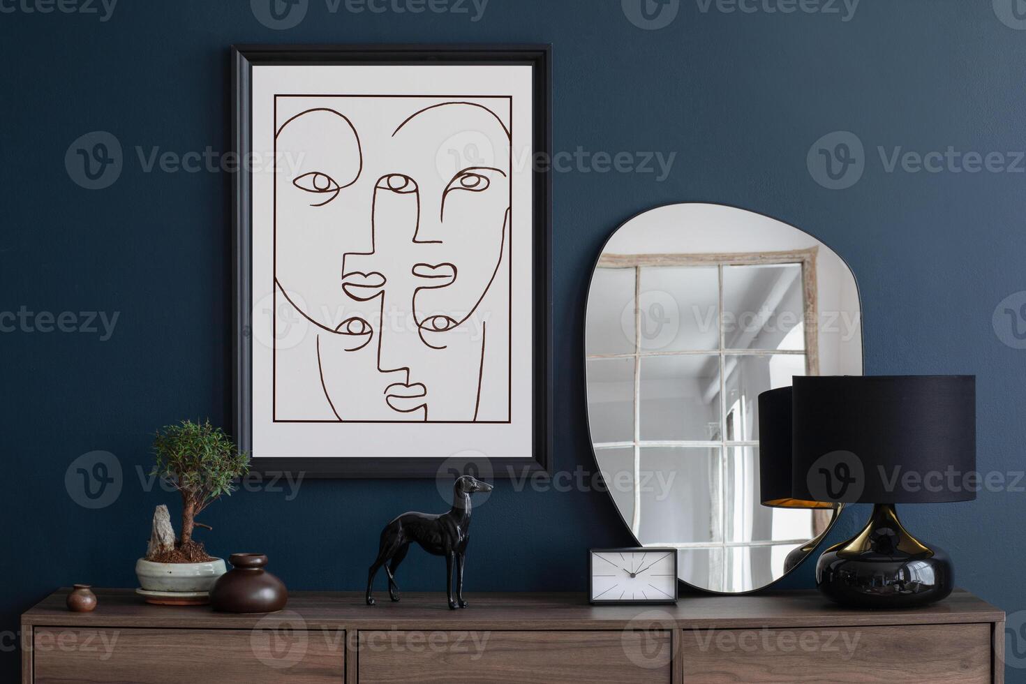 Creative composition of modern living room interior design with mockup poster frame, wooden commode, mirror and elegant personal accessories. Blue wall. Home staging. Template. Copy space. photo
