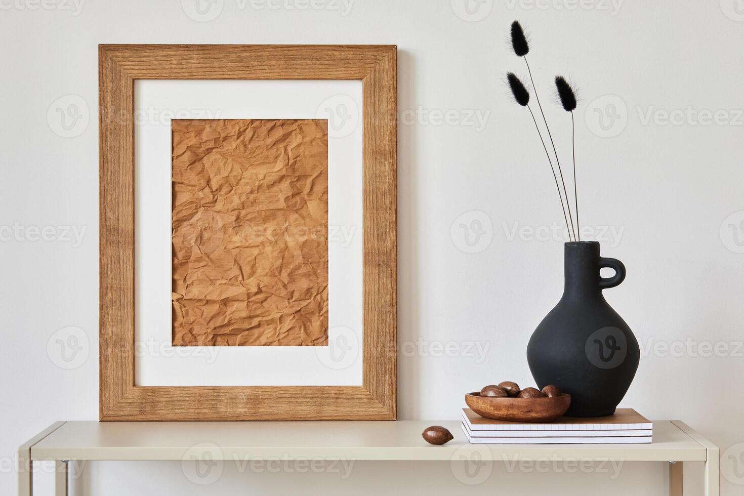 Minimalist composition of living room interior with mock up poster frame, beige commode, vase and personal accessories. Copy space. Template. photo