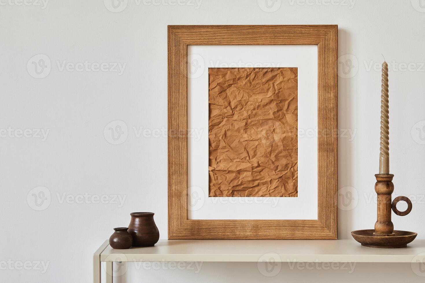 Minimalist composition of living room interior with mock up poster frame, beige commode, vase and candlestick. Copy space. Template. photo