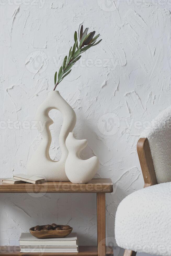 MMinimalist living room interior composition with handmade vases, side table, fluffy armchair and personal accessories. Structure wall. Copy space. Wallpaper. Template. photo