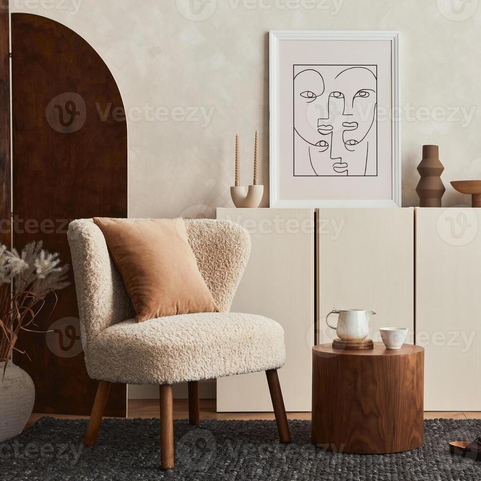 Stylish composition of cozy living room interior design with mock up poster frame, fluffy armchair, folding screen, coffee table, commode and personal accessories. Modern style - Template. photo