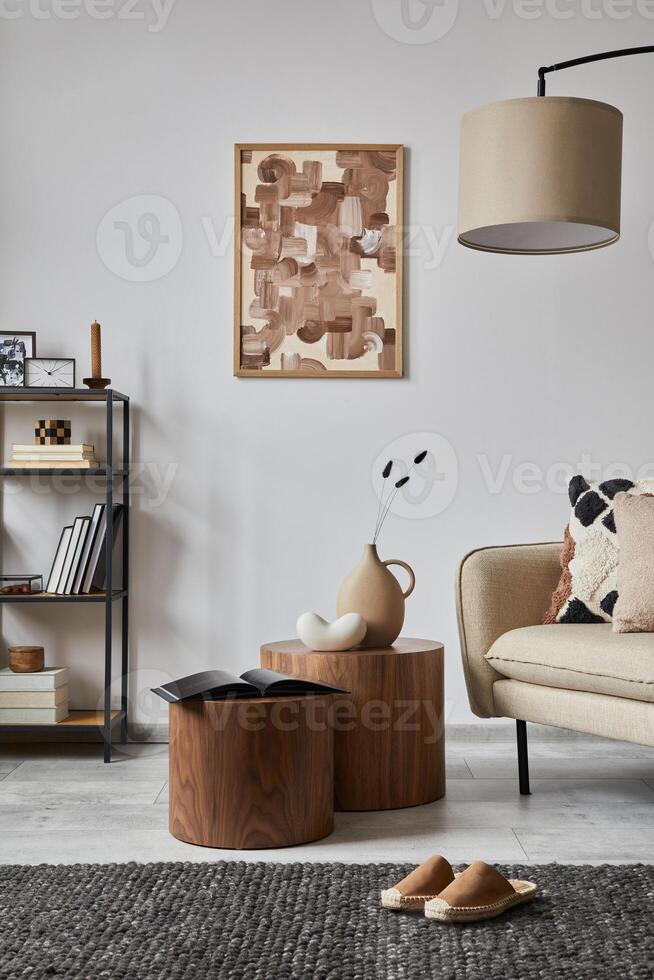 Minimalist interior of elegant living room with mock up poster frame, beige modern sofa, wooden side tables and personal accessories. Creative home staging. Copy space. Template. photo