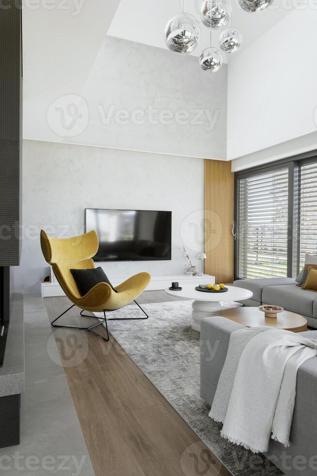Stylish composition of living room interior with corner beige sofa, coffee table, carpet on the floor and minimalist accessories. Panoramic window. . photo